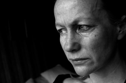 Closeup of a sad woman seeking Spousal Support. Image is in black and white